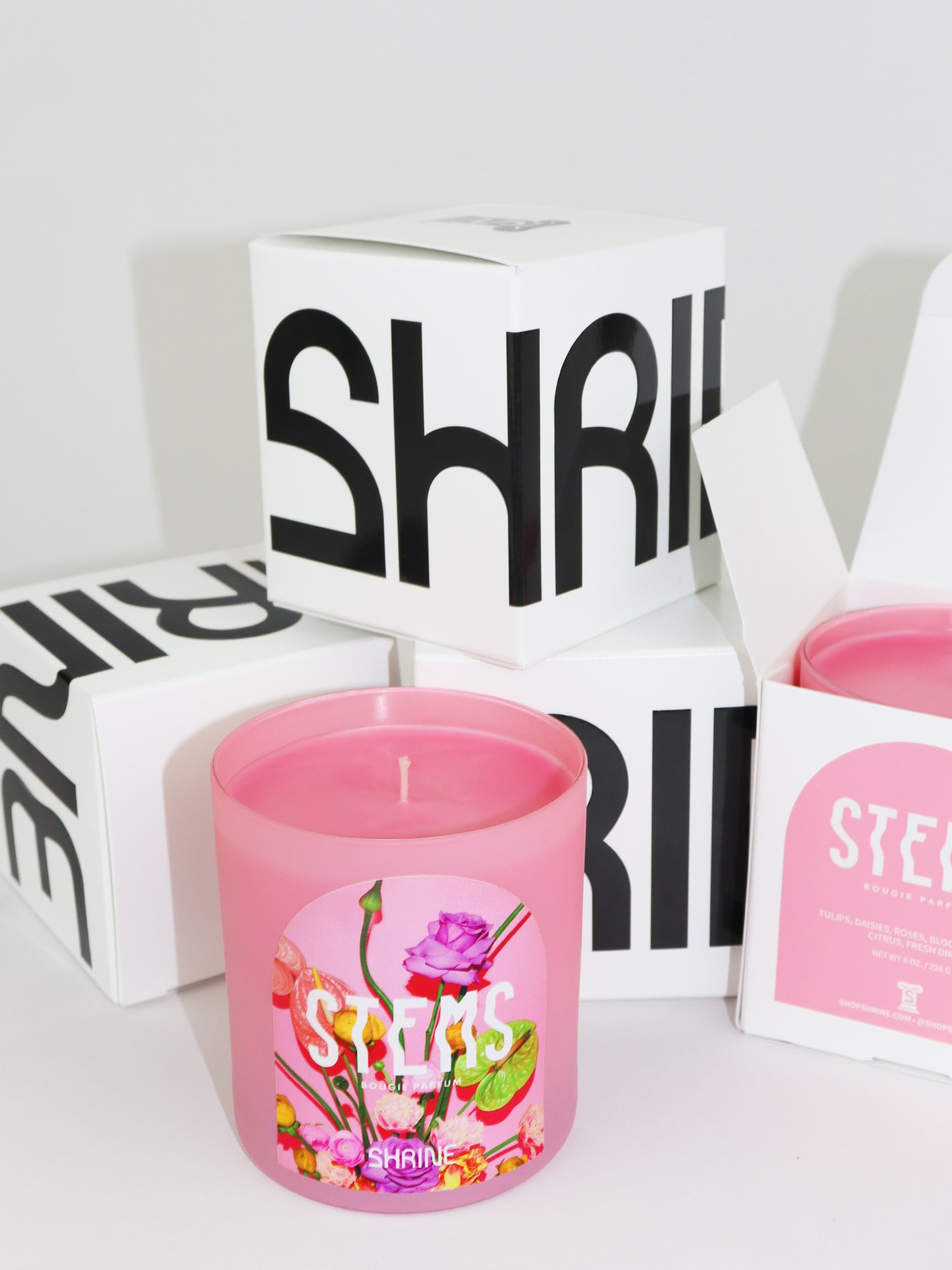 shrine stems pink floral candle with roses and anthurium flowers on the label black and white candle box shop shrine shopshrine